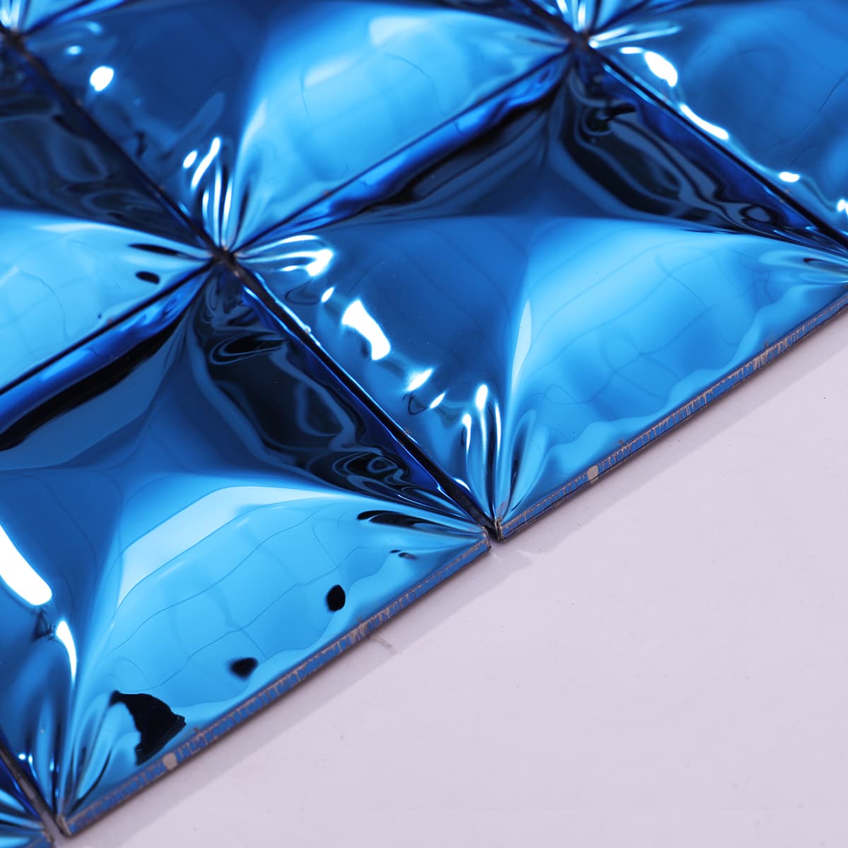Edge close-up of blue mirror stainless steel mosaic tile