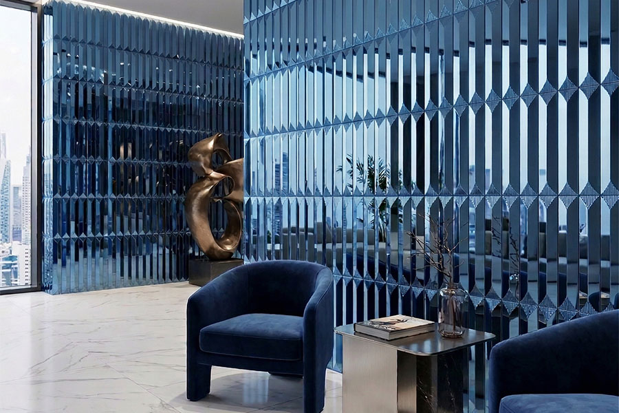 Textured blue glass wall and deep blue velvet armchair in a contemporary luxury space.