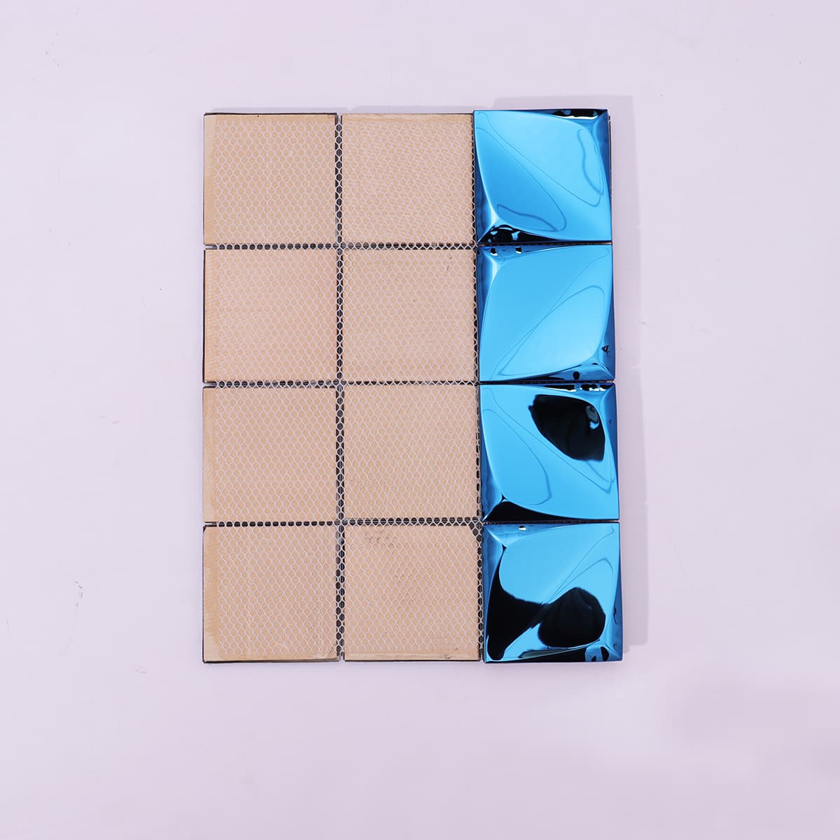 Mesh-backed blue pyramid 3D metal mosaic tile sheet showing backside