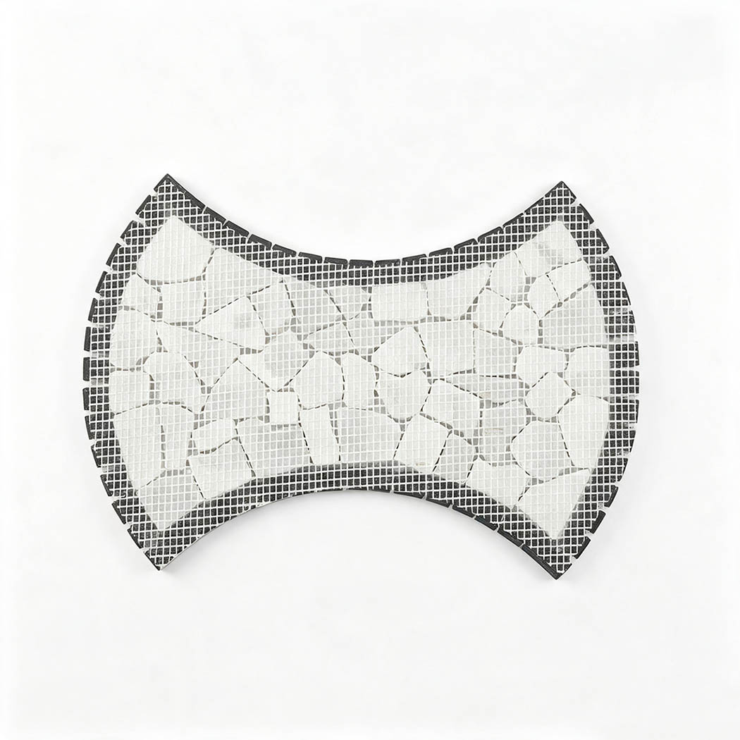 Mesh-backed reverse side of bow tie shaped white marble pebble mosaic tile