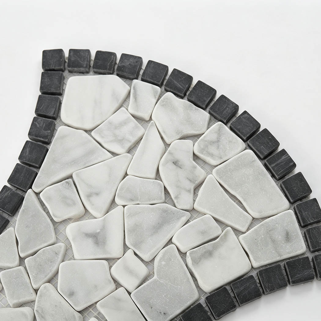 Close-up of white marble pebble mosaic with a dark charcoal border