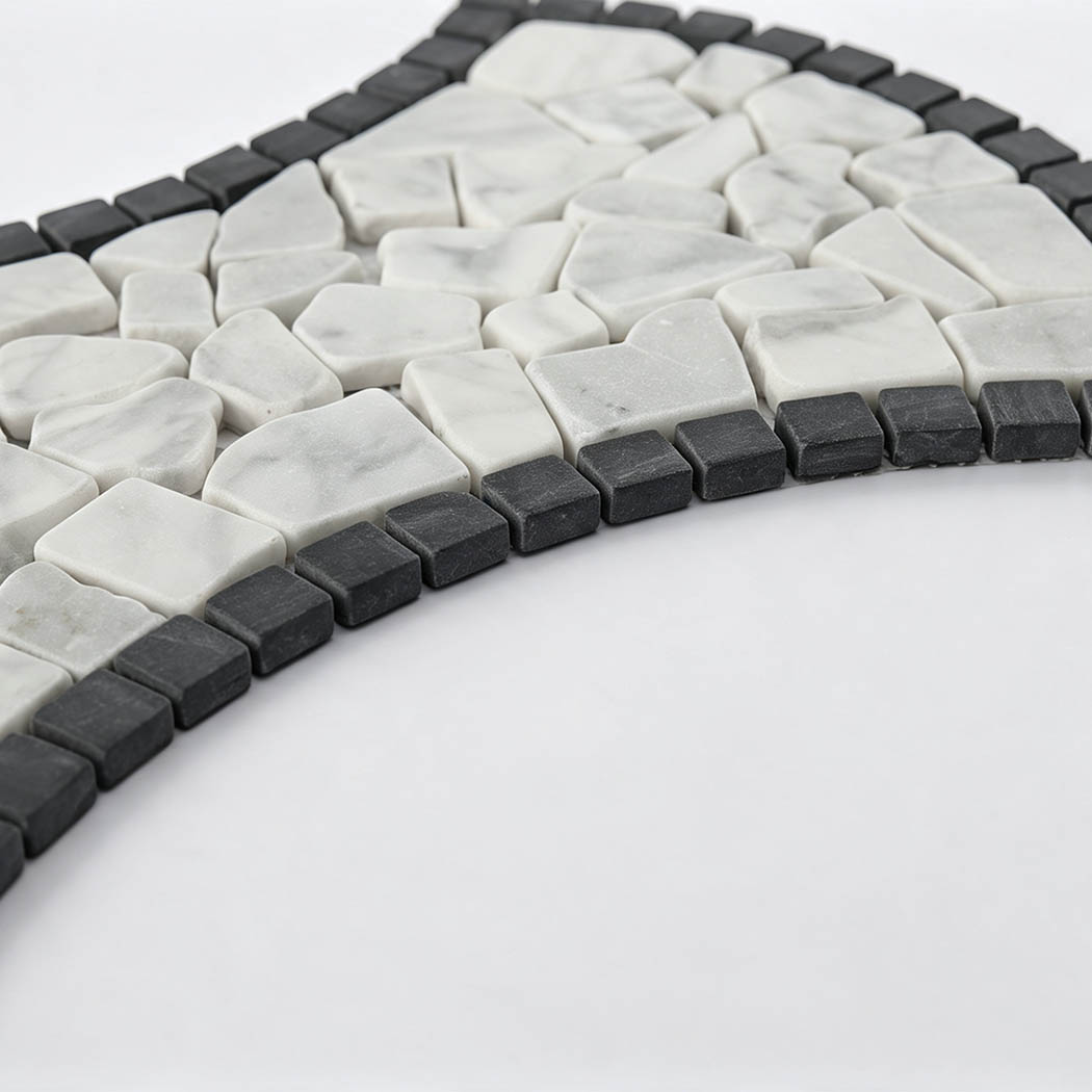 Angled view showing white marble pebbles and raised dark border mosaic tiles