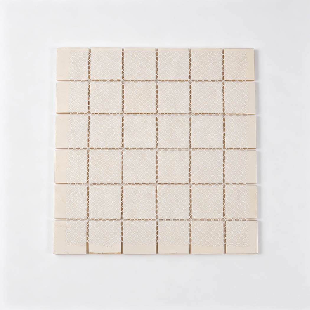 Back view of bright yellow square glass mosaic tile sheet with white mesh backing