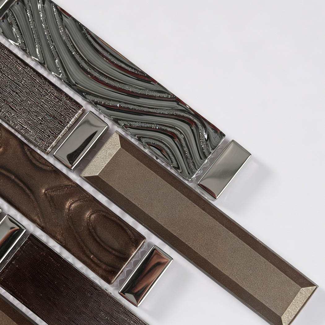 Close-up of bronze gray and taupe glass linear mosaic with wavy and beveled strips