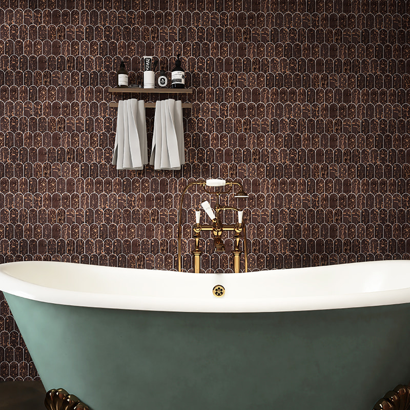 Brown arch mosaic tile wall with gold veins behind freestanding tub