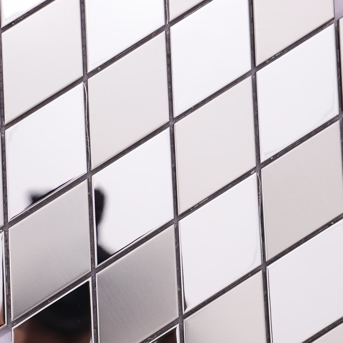 Close-up of brushed and mirror silver diamond mosaic surface