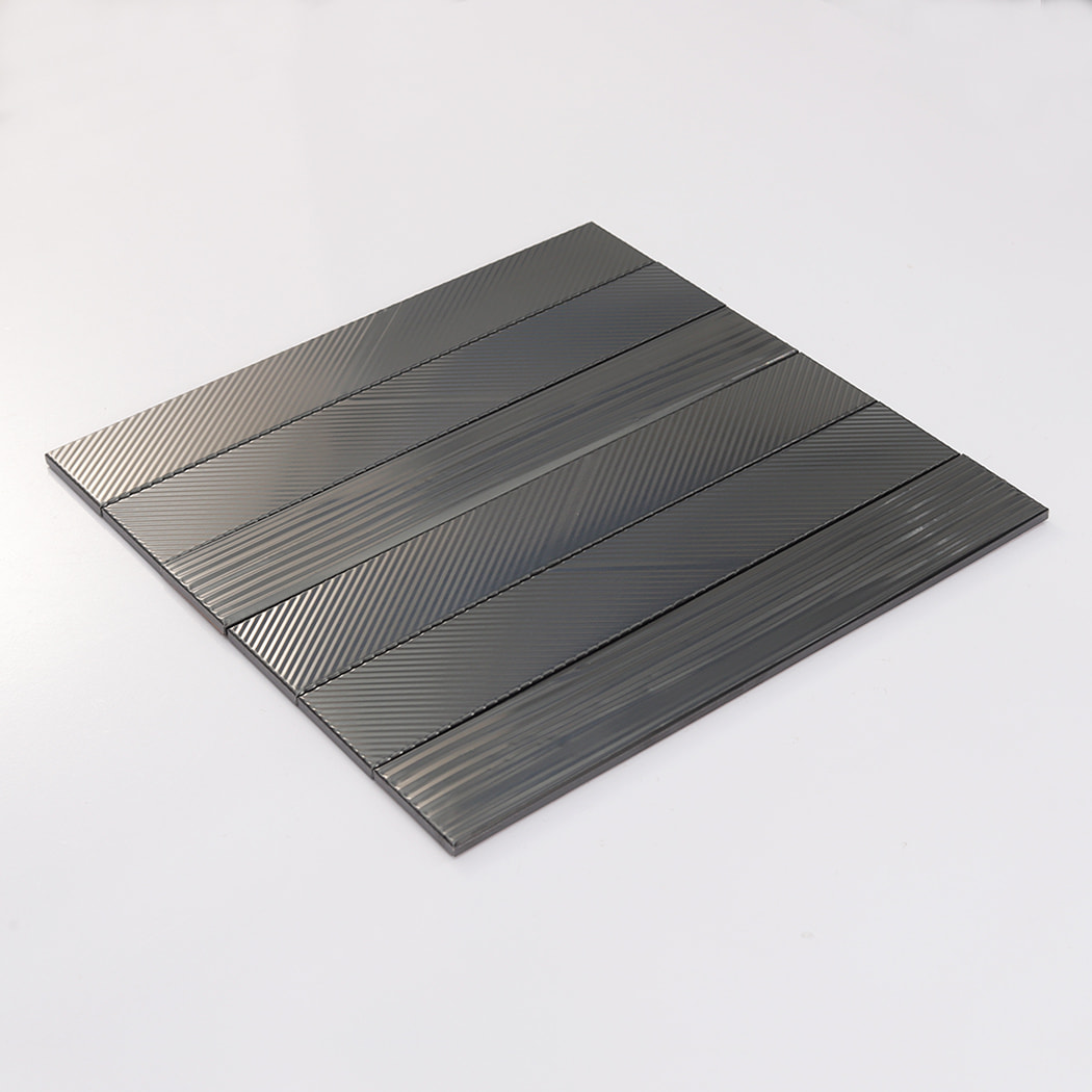 Angled display of brushed black stainless steel mosaic sheet with grooved stripes