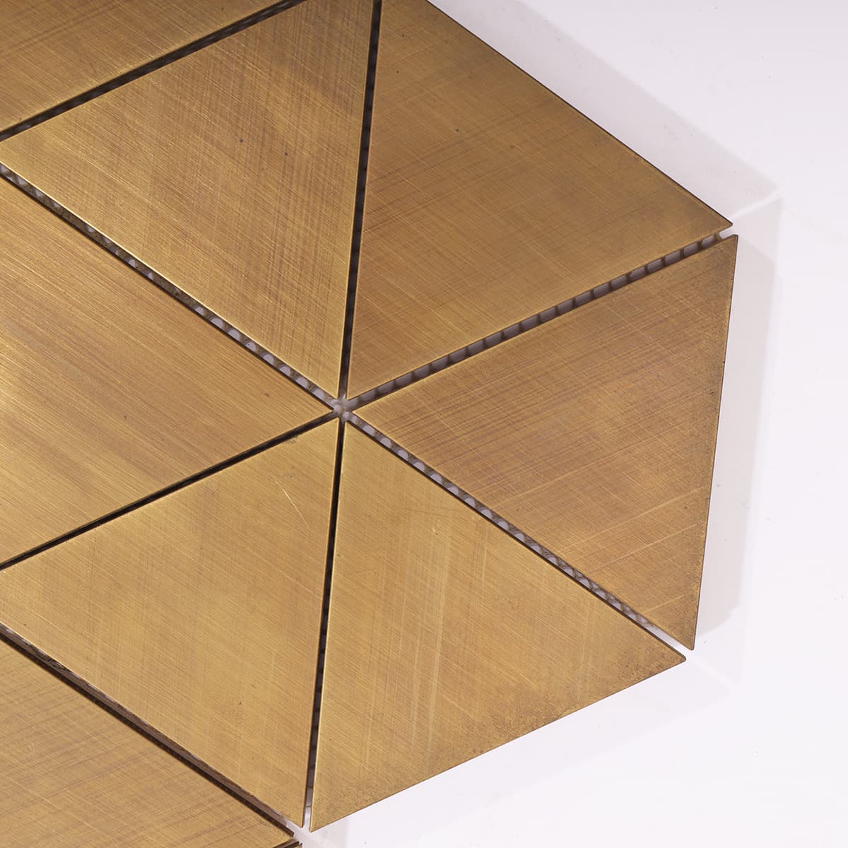 Zoomed view of triangle brass mosaic corner joint