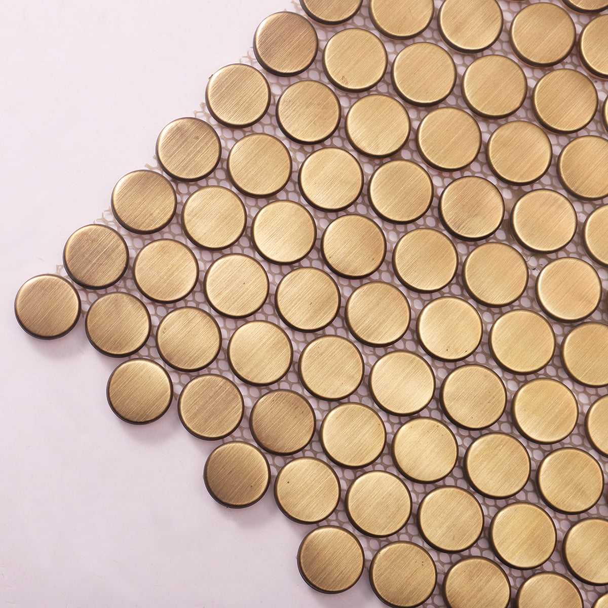 Close-up of brushed gold round mosaic tiles showcasing clean and sleek design