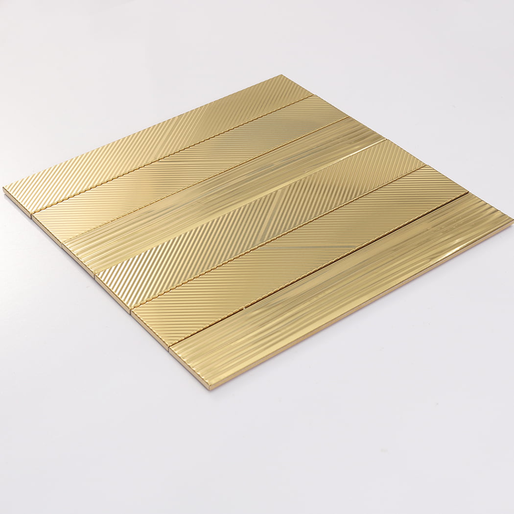 Angled display of brushed gold stainless steel mosaic sheet with grooved surface