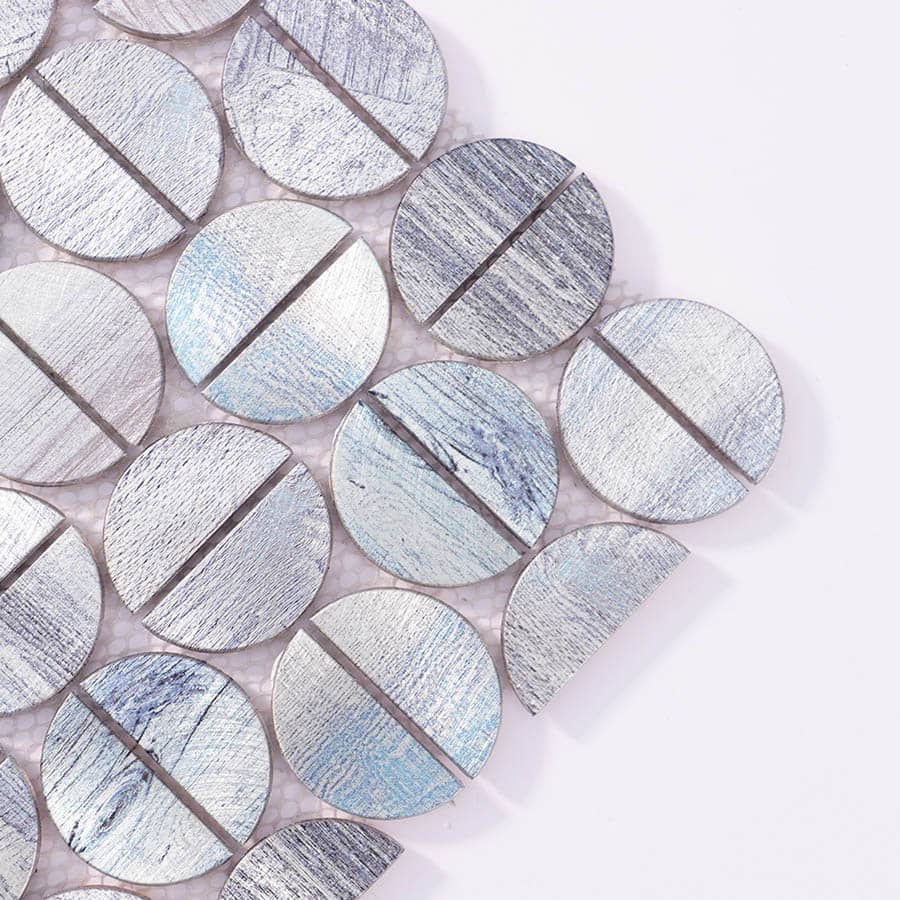 Close-up of corner detail in brushed silver and blue aluminum round mosaic