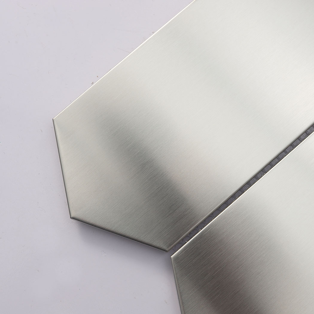 Close up detail of brushed silver elongated hexagon metal mosaic tile.