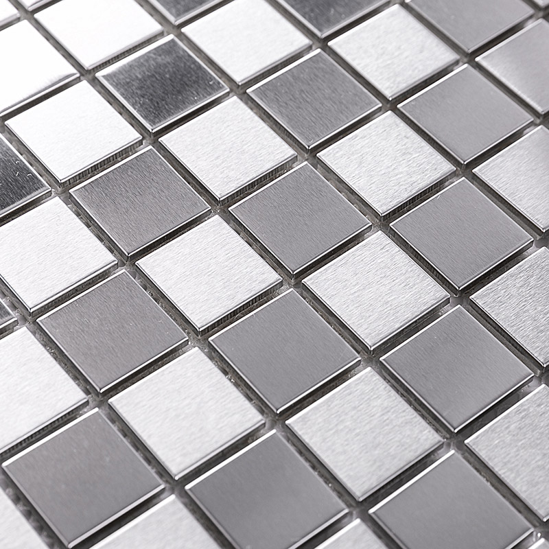 Close-up view of brushed silver and grey square metal mosaic tiles arranged in a grid.