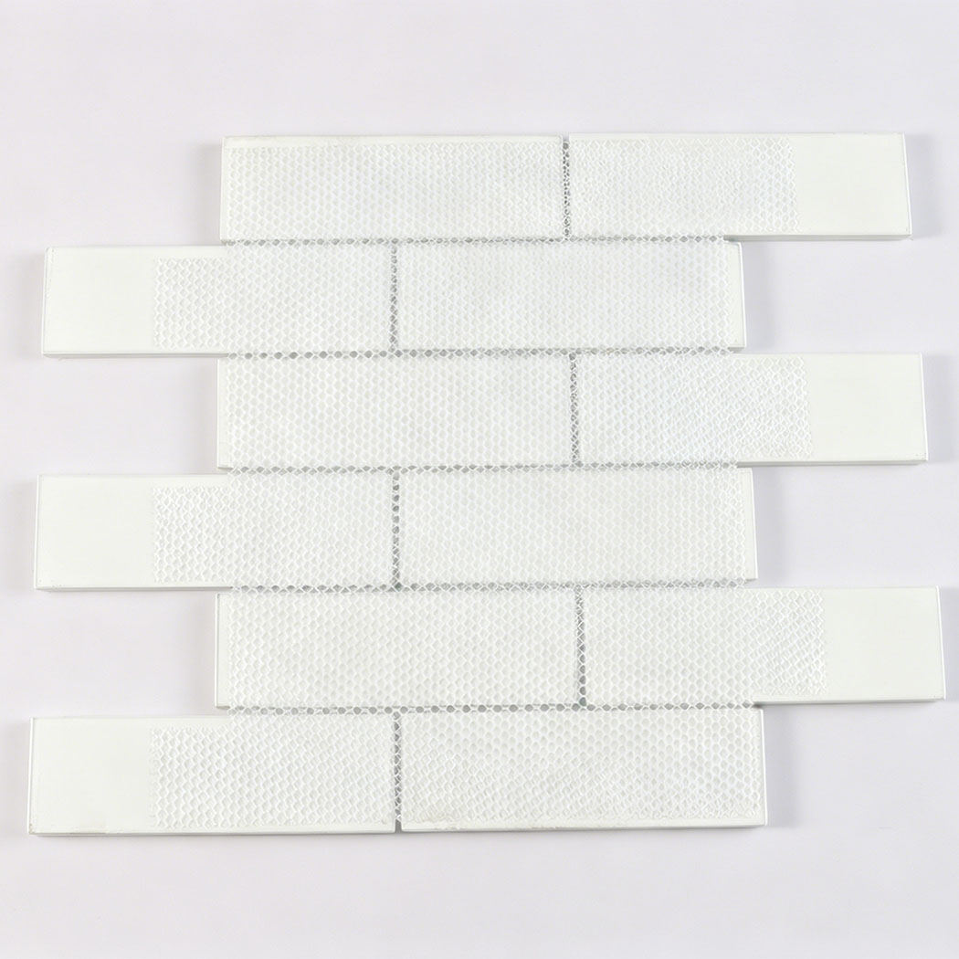 White mesh mounted back of Calacatta glass subway tile sheet