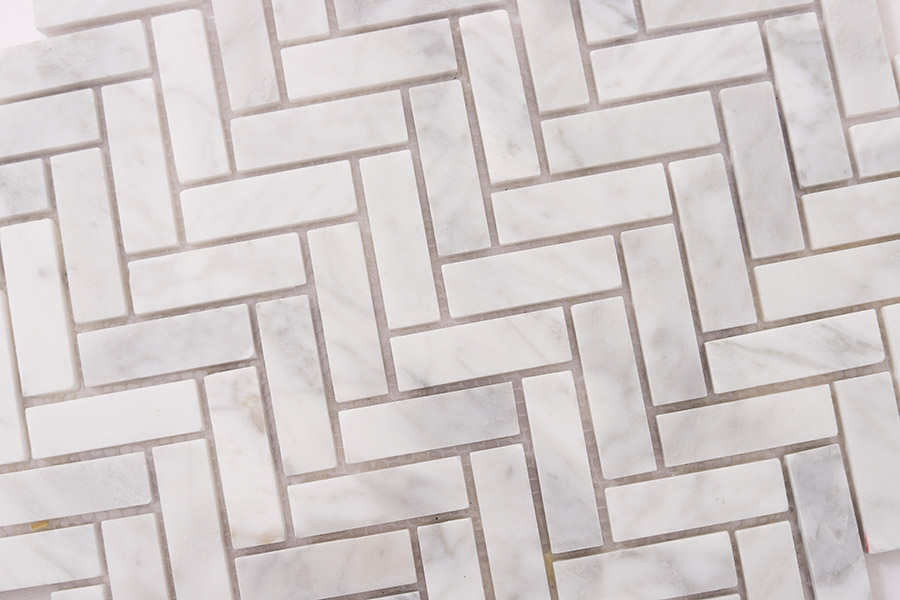 White Carrara herringbone tiles in 15x48mm size for luxury kitchen backsplash decor.