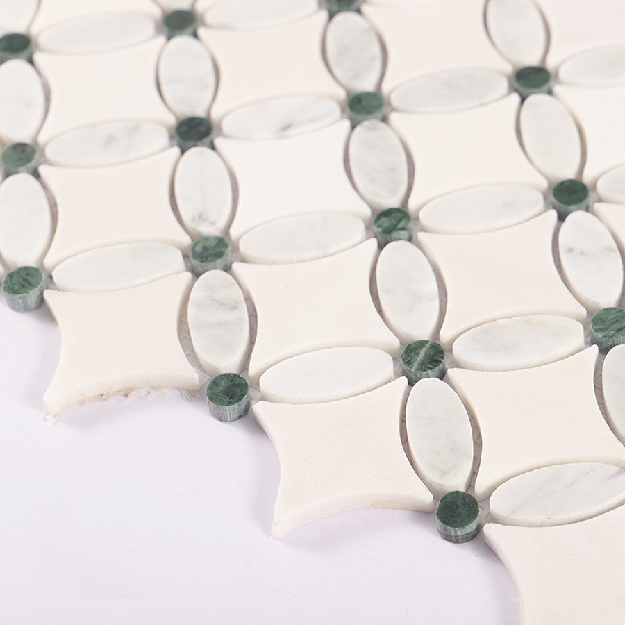 Angled view of Carrara white and green flower marble mosaic tile surface