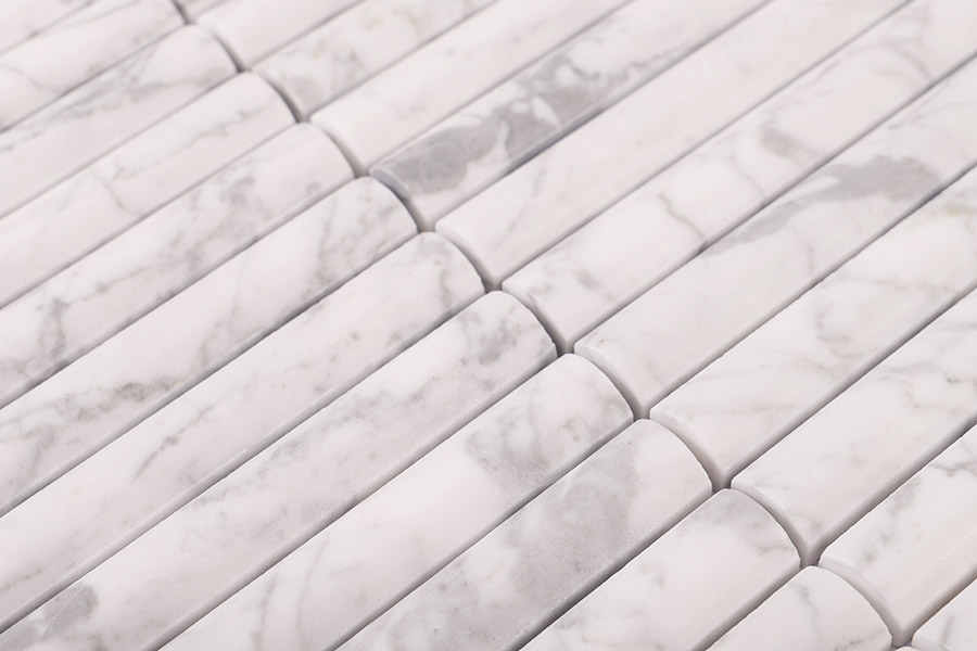 Close-up of Carrara white reeded marble tiles with natural grey veining for luxury feature walls.