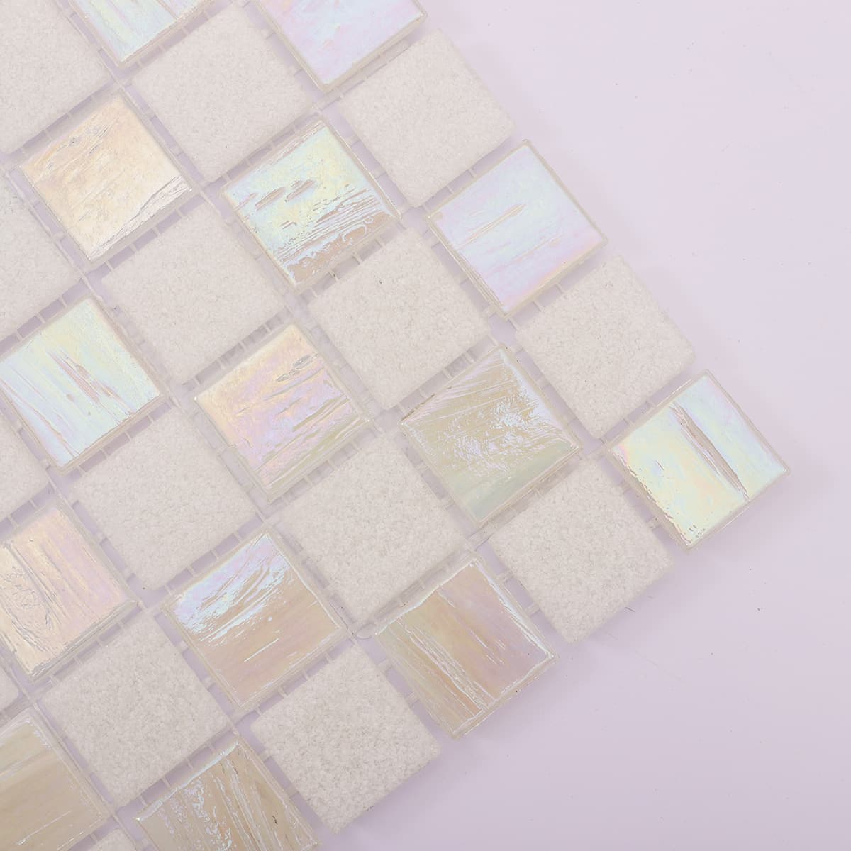 Corner close-up of white frosted and iridescent glass mosaic tiles