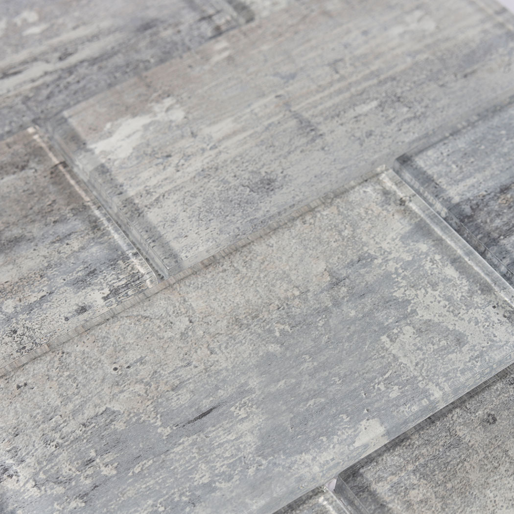 Detailed texture view of clear glossy glass surface over industrial cement patterns.