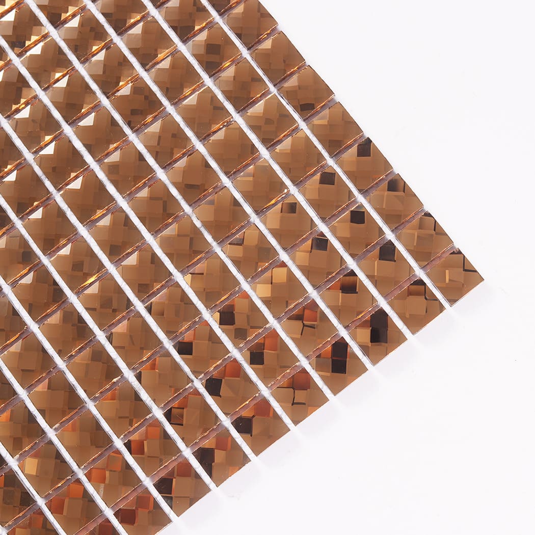 Close-up angled corner view of a bronze crystal mirror glass mosaic tile sheet.