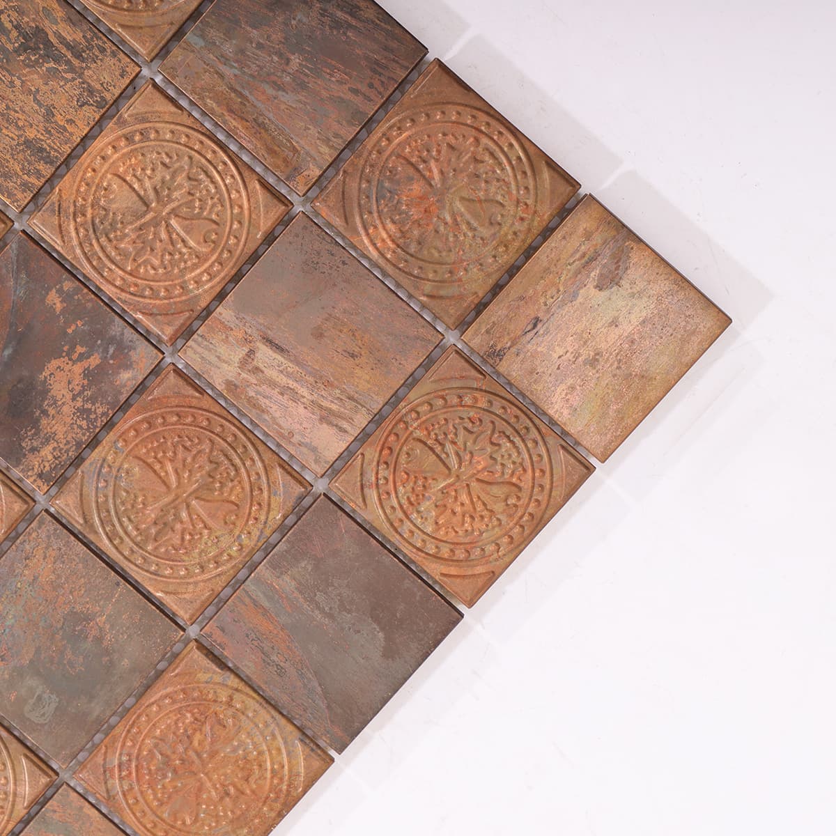 Detail of vintage copper mosaic tiles with embossed round design