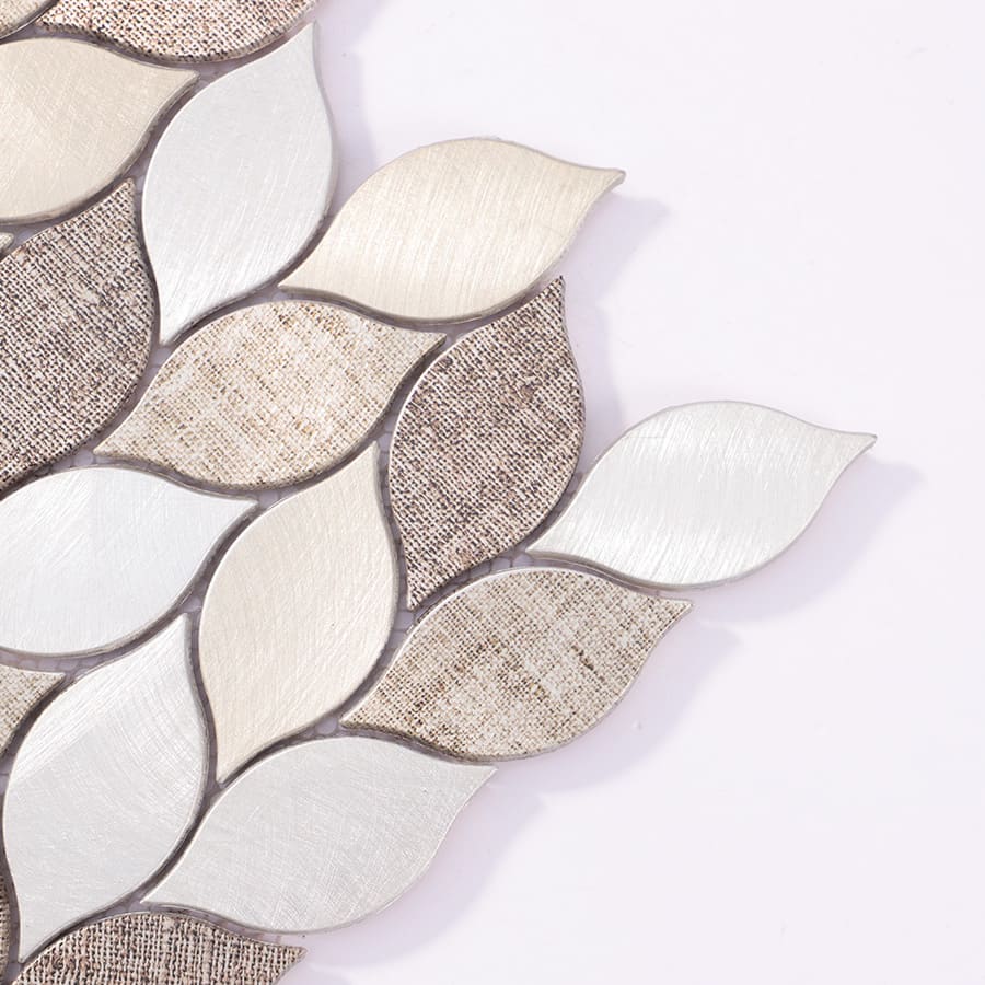 Close up corner of beige and silver leaf aluminum mosaic tile
