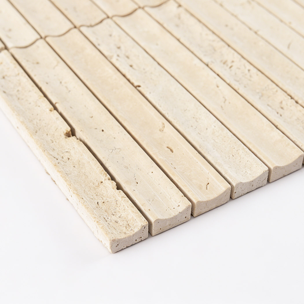 Close up edge view of beige travertine linear mosaic tile with natural stone pores