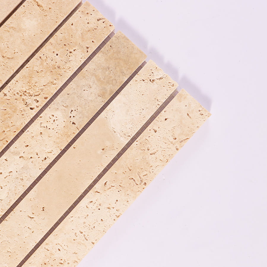 Close up of beige travertine strip mosaic tile corner detail
