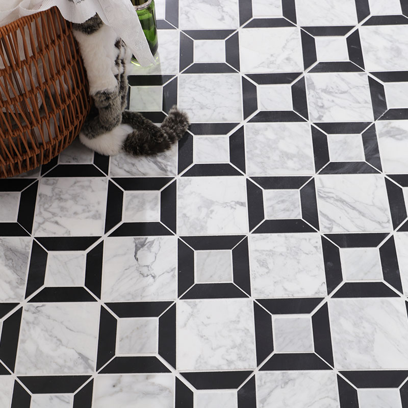 Close up of black and white geometric marble tile with framed square pattern