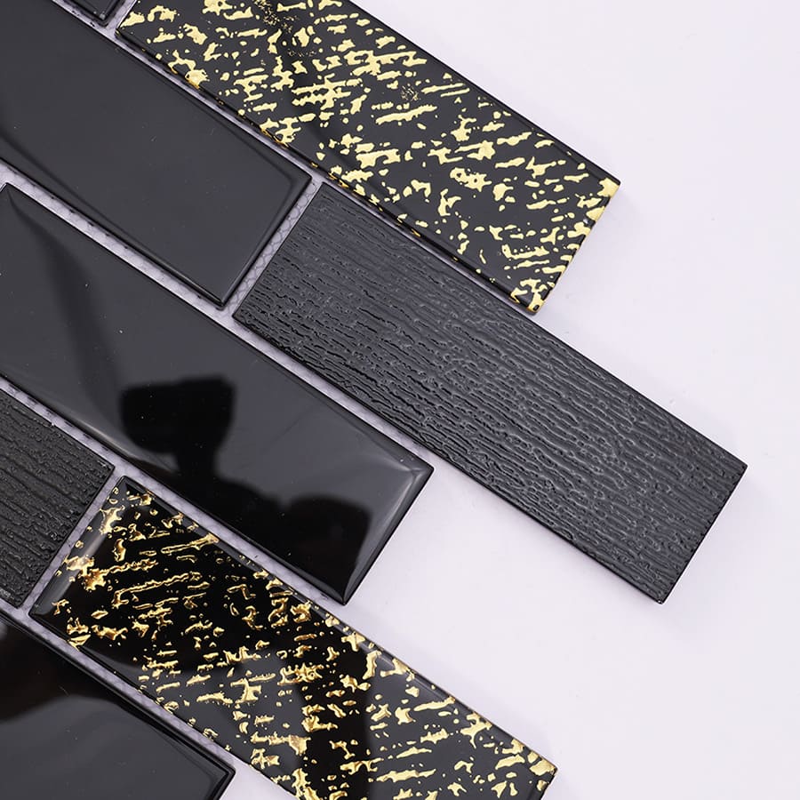 Close up of black and gold glass mosaic subway tile showing glossy and textured finish