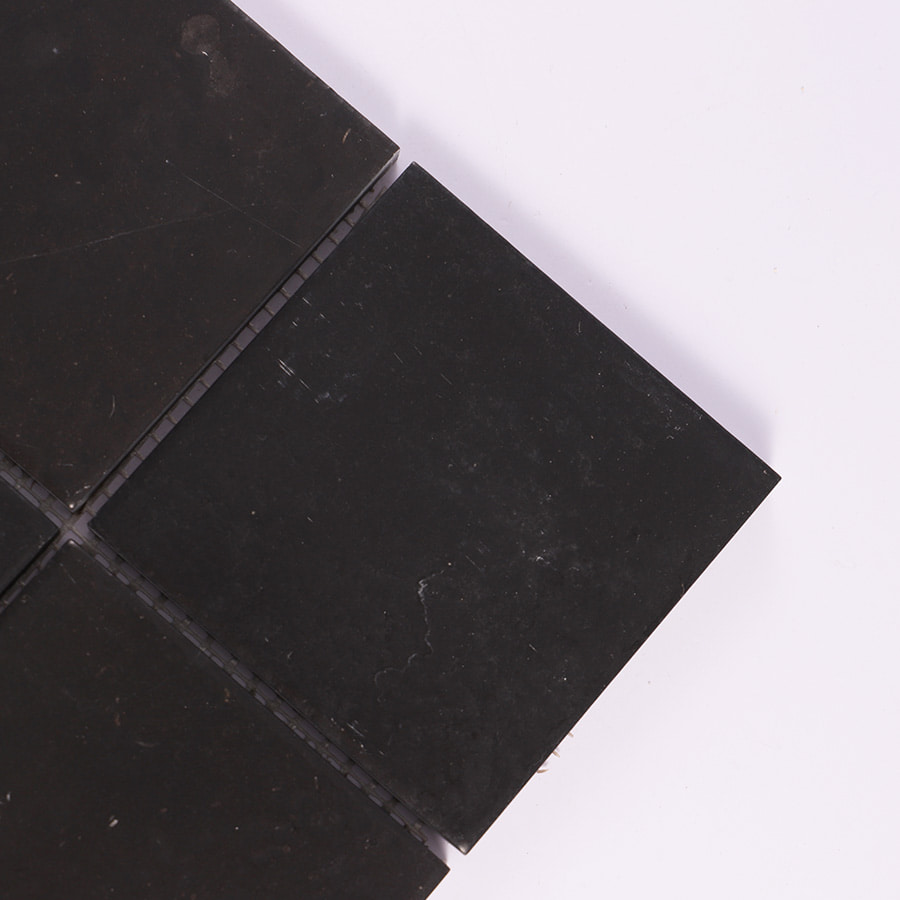 Close up of black stone mosaic tile corner details