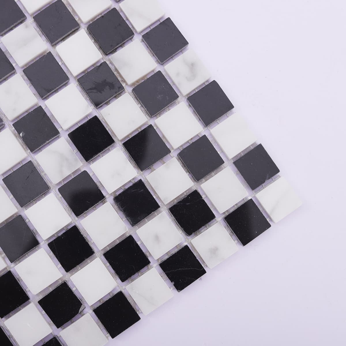 Corner close-up showing black and white square marble mosaic tile details
