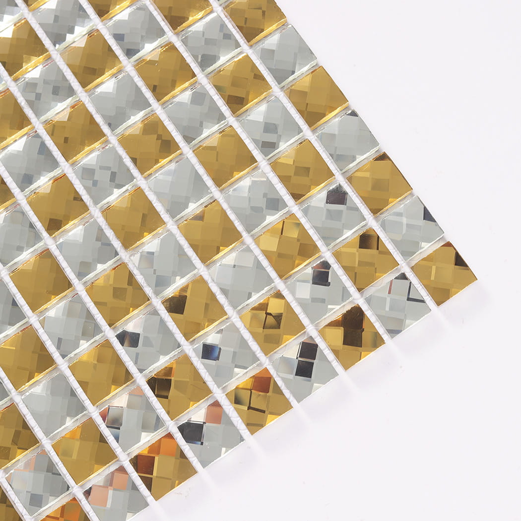 Close-up angled view showing beveled edges of gold and silver glass mosaic chips