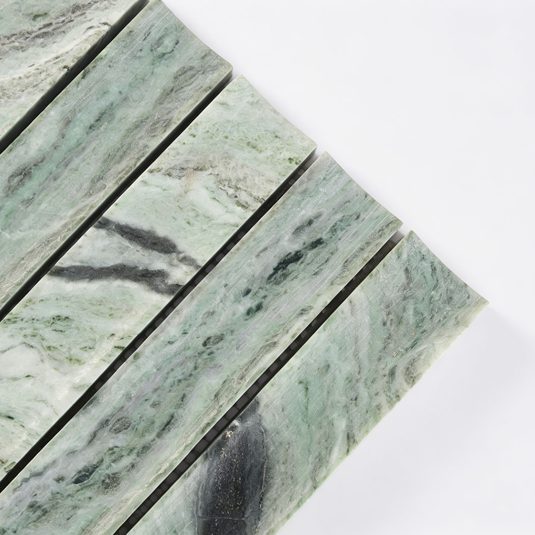 Close up corner view of green marble curved fluted mosaic tile with layered veining