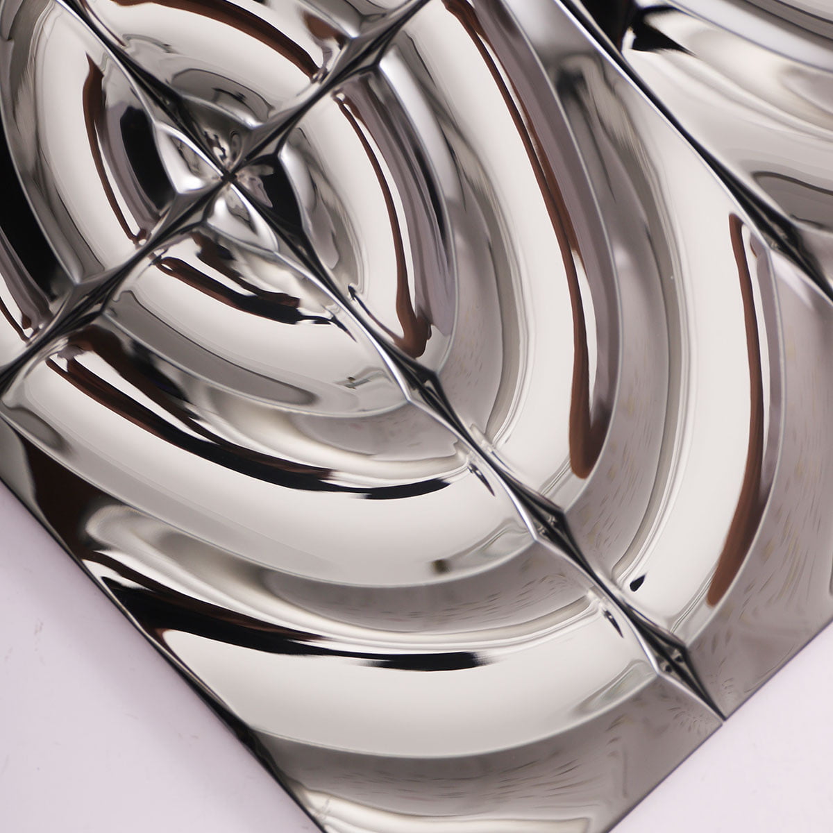 Detailed close-up of a metallic wavy tile surface, showing reflective design