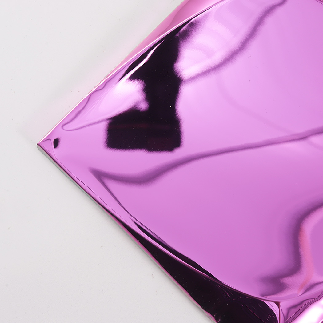 A detailed close up shot of the smooth corner and metallic surface of a pink 3D tile.