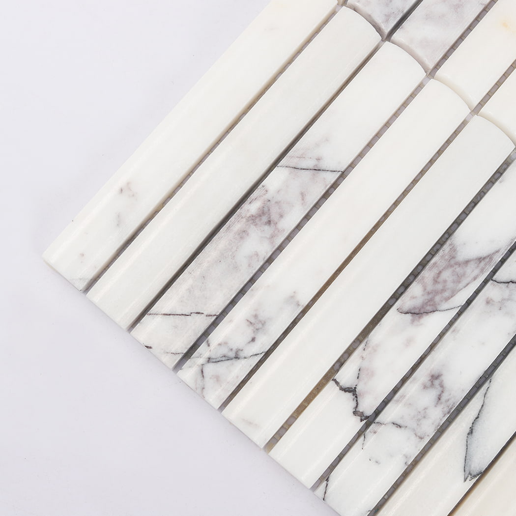 Detailed close-up showing the soft grey veins on natural white marble tile strips.