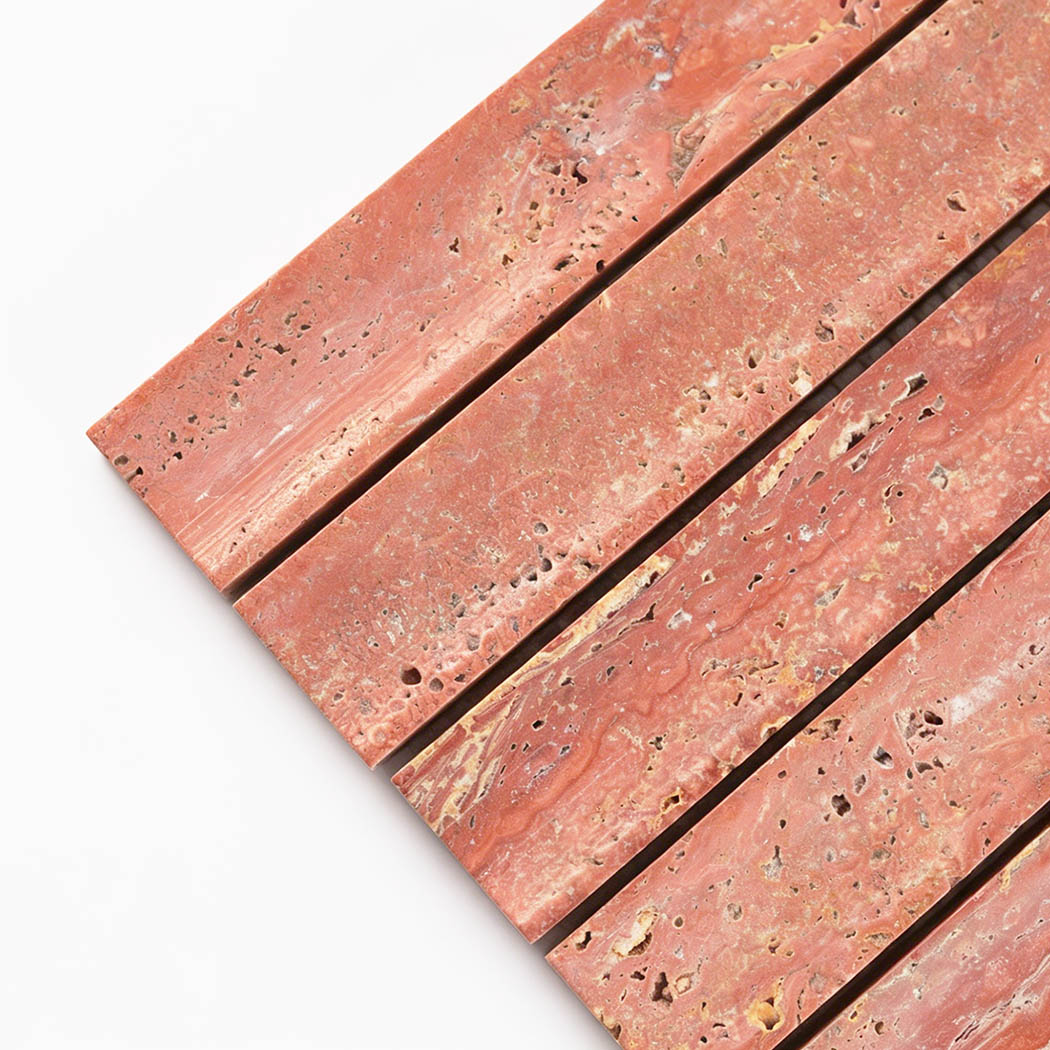 Close up corner view of red travertine curved fluted mosaic tile with stone pores