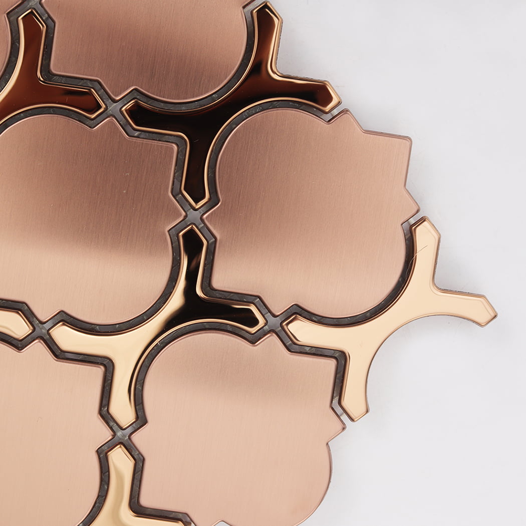 Close up of rose gold arabesque tiles showing the interlocking metal pieces.