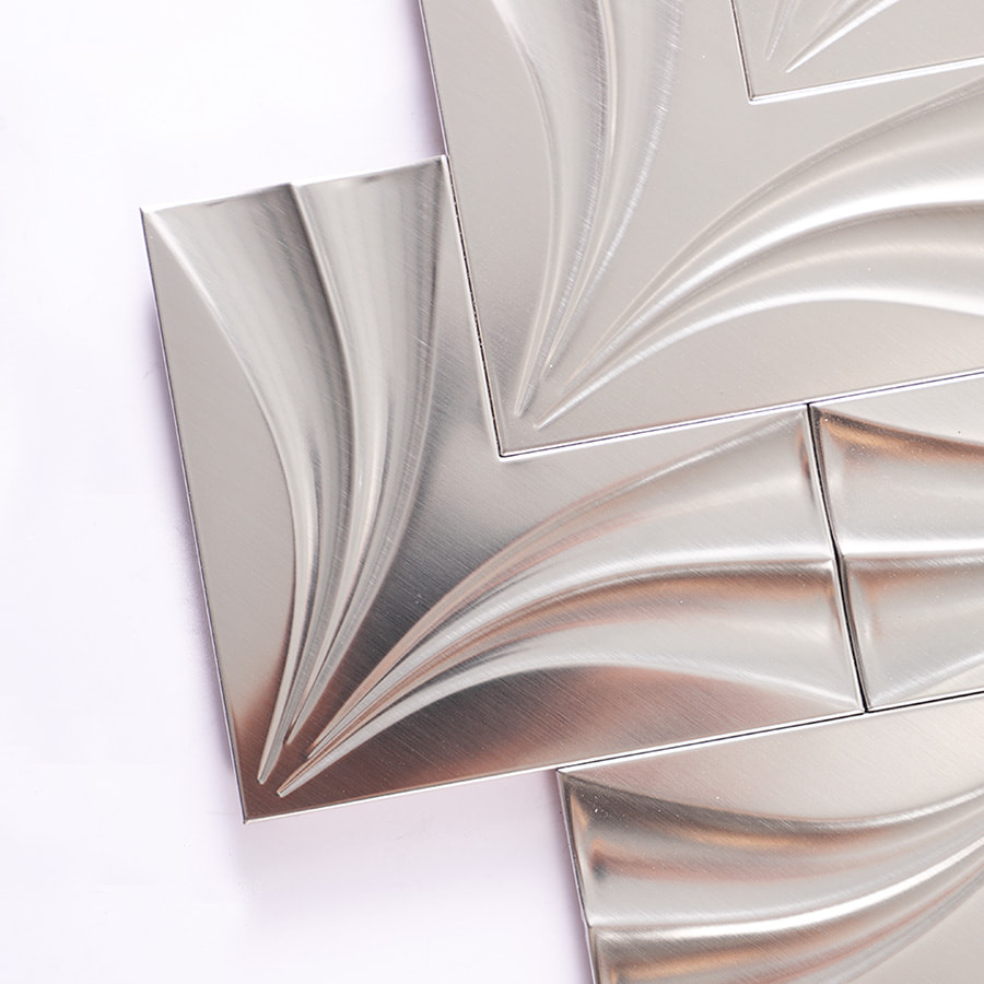 Close-up of corner detail on stainless steel chevron tile surface