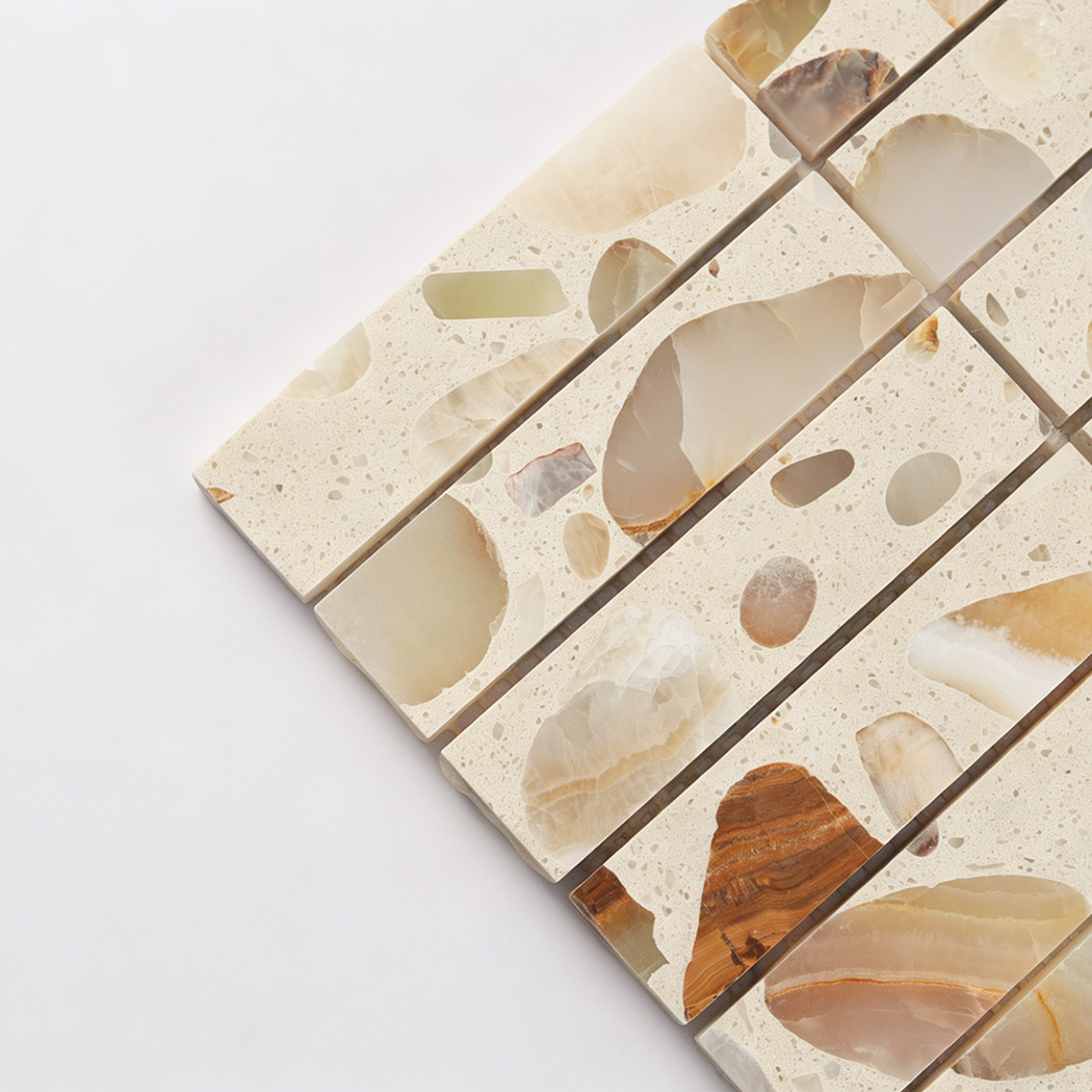 Close up of terrazzo mosaic tile showing rectangular chips and polished surface