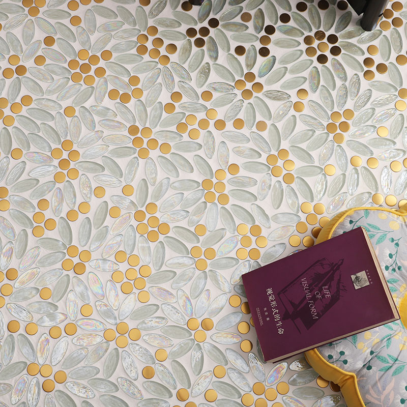 Close-up of iridescent white and green petal mosaic tiles with gold flower centers