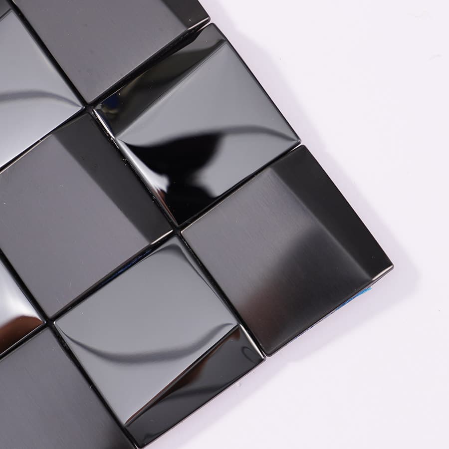 Close-up of black glossy and brushed 3D stainless steel mosaic tile corner