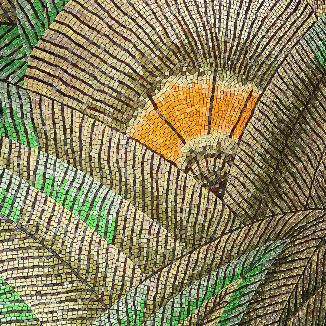 Close-up of fan-shaped leaf pattern in green, brown, and orange mosaic