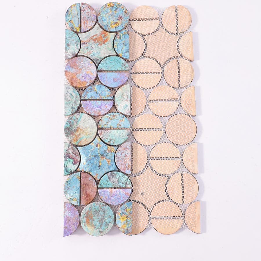 Backside of aluminum mosaic tile sheet with mesh backing and half tile rows