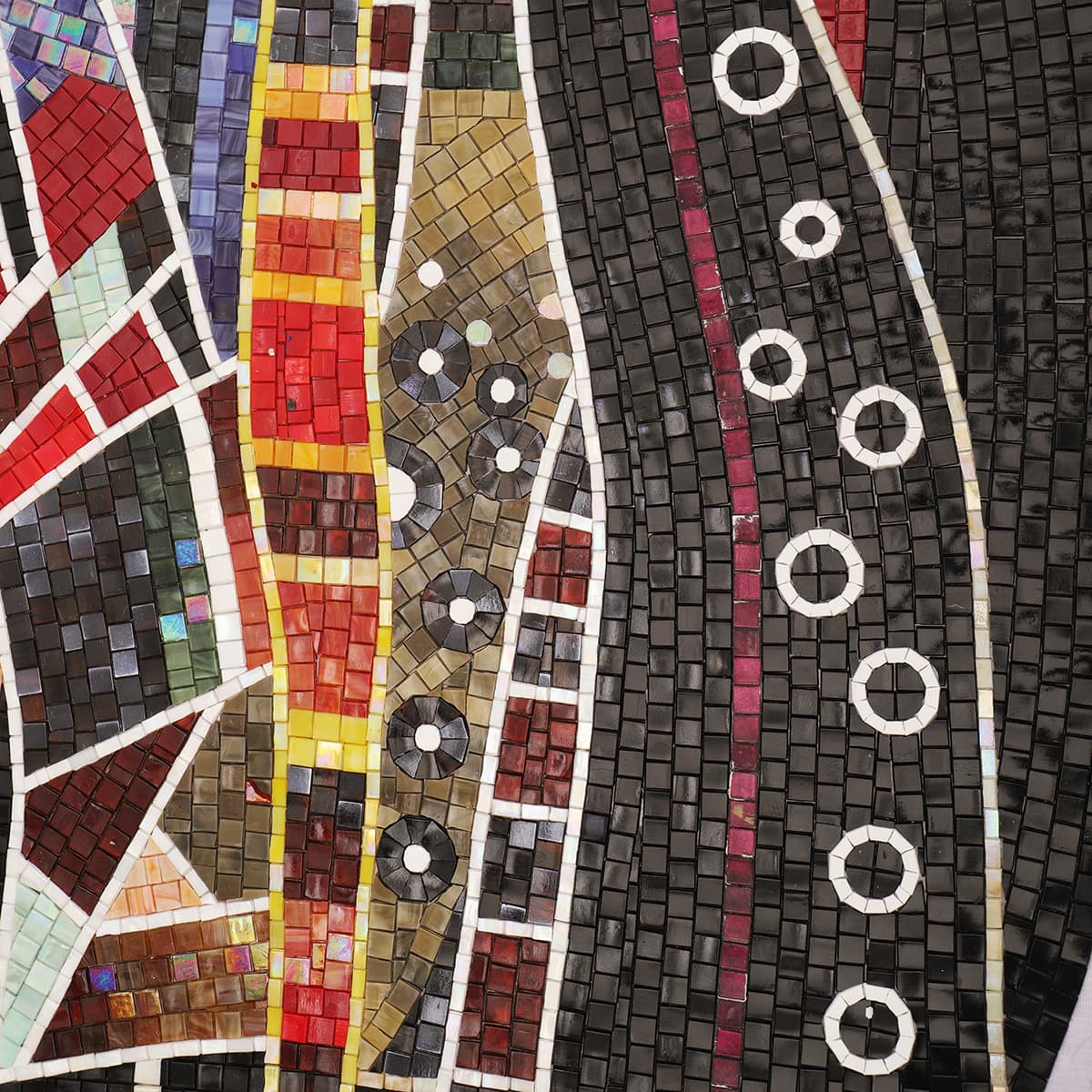 Artistic horse mosaic close-up with black, red, and circular tile patterns