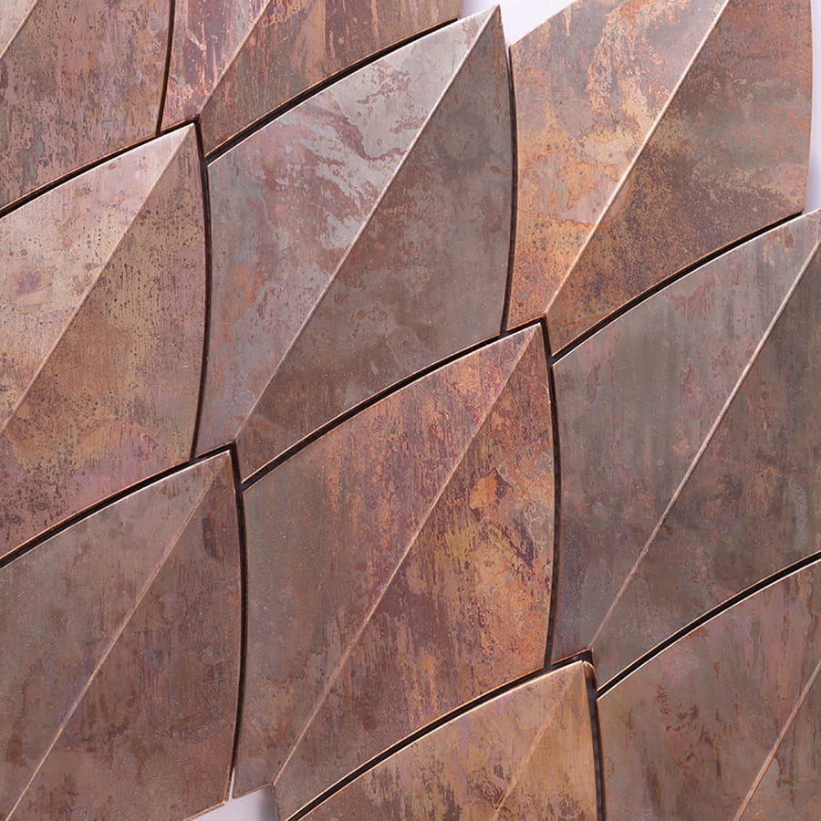 Close-up of copper diamond tiles highlighting metallic surface texture.