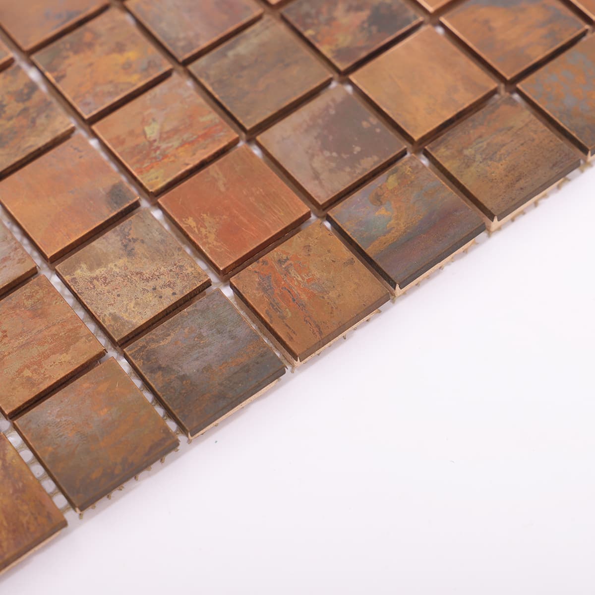Side edge of flat copper mosaic with patina finish