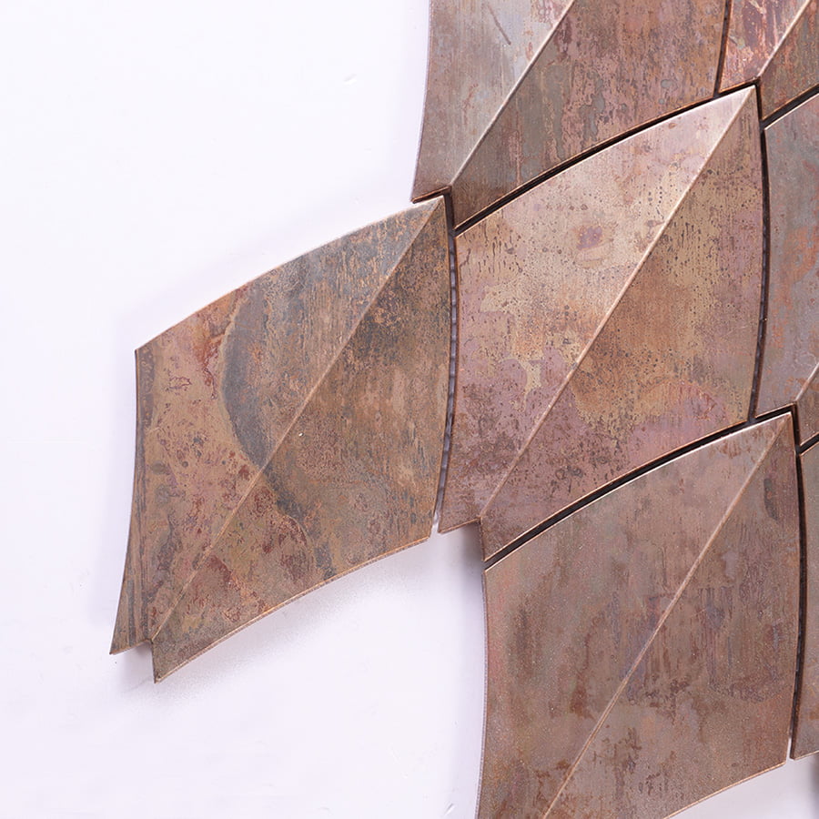 Close-up showing the edge connection of copper diamond mosaic tiles.