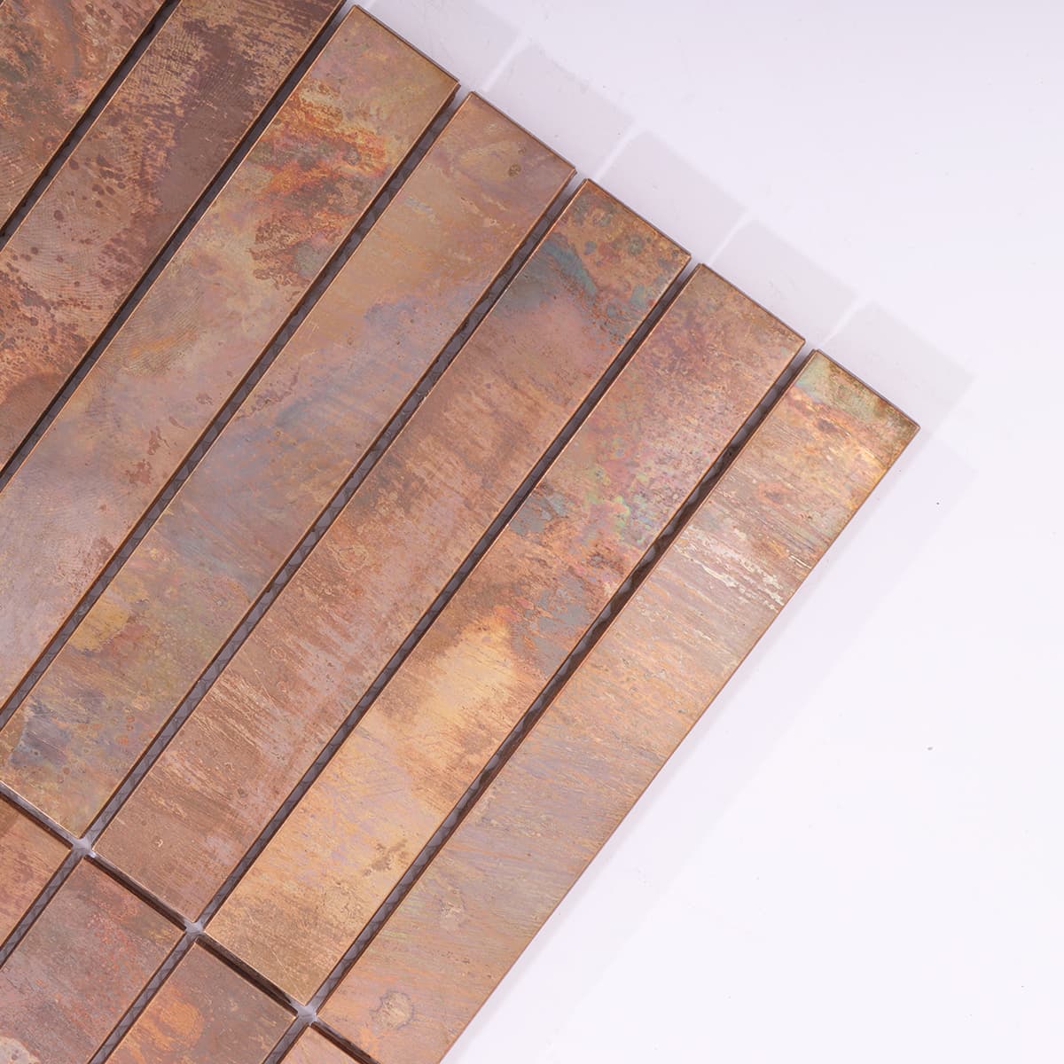 Corner close-up of long strip copper mosaic tile
